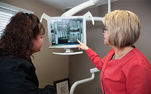 Dr. Berg's dental hygienist using modern technology